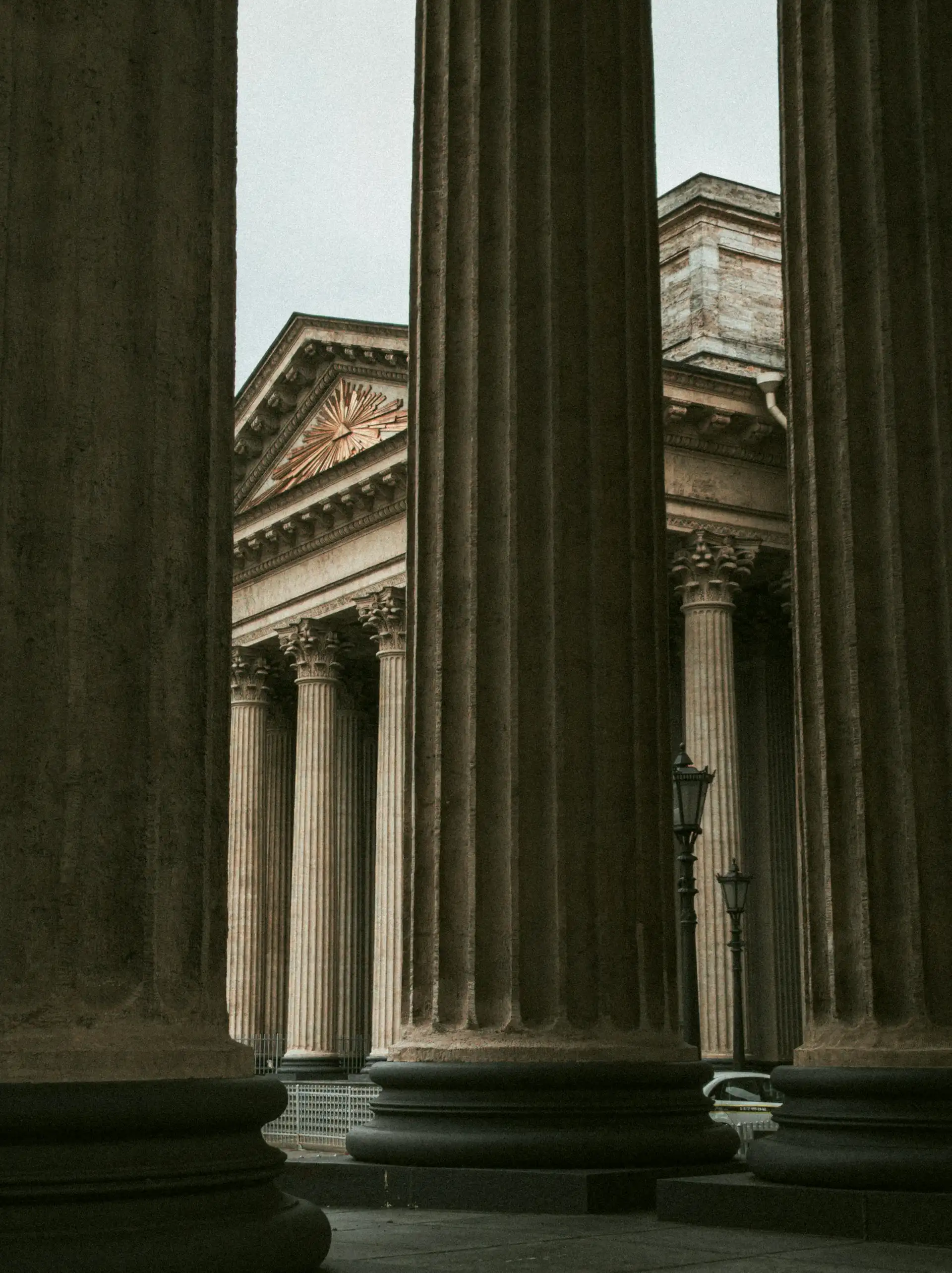 Close-up of majestic, classical architectural columns, representing stability and strength in investment strategies.